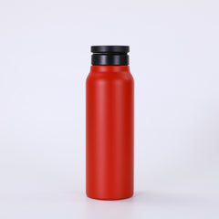 Red water bottle with a black lid on a white background