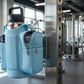 blue crossbody bag attached to a metal bar in a gym setting