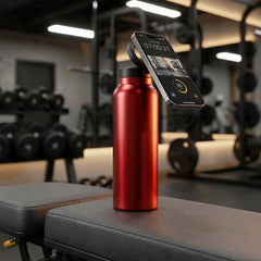 Red water bottle with a digital scale on a gym bench